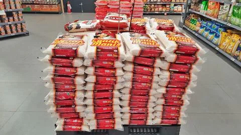 Stack of premium packed rice bag 5kg ready for sell in the supermarket Stock Photos