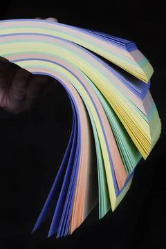 A stack of printed matter in the hands. Earnings in the printing house. Cowor 스톡 사진