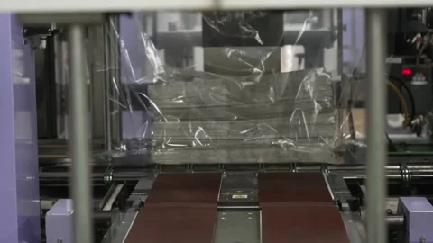 Stack of printed newspapers automatically wrapped and heat sealed in Stock Footage 337889835