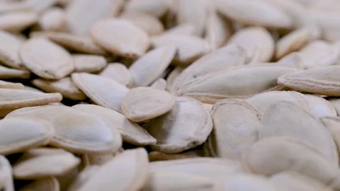 Stack of pumpkin seeds with shell. Slider shot. Depth of field Stock Footage 296554199