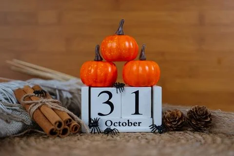 Stack of pumpkins with October 31 wooden block calendar Stock Photos
