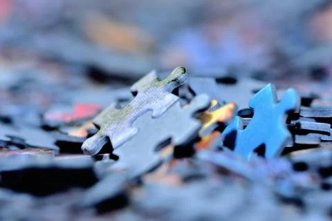 Stack of puzzle pieces. Close-up detail macro. Stock Photos