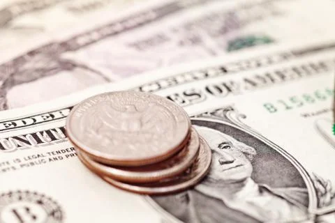 Stack of quarters on american banknotes Stock Photos