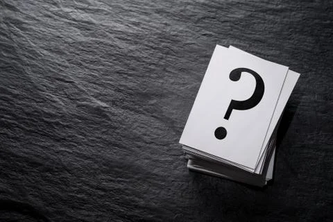 Stack of question mark cards on the stone table with copy space Stock Photos