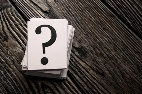 Stack of question mark cards on the wooden table with copy space Stock Photos