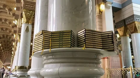 Stack of Qurans placed by a pillar inside Al-Masjid Stock Footage 332963461