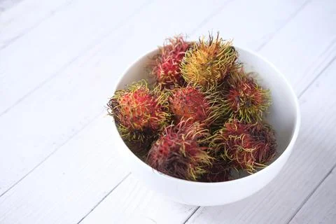 Stack of rambutan in a bowl on table 스톡 사진