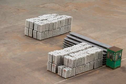 Stack of raw aluminium ingots in a warehouse at a trading port Stock Photos