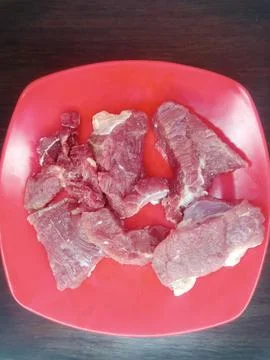 Stack of Raw Meat in a Container Ready for Cooking Stock Photos