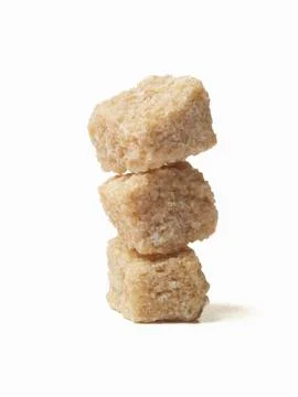 Stack of Raw Sugar Cubes; White Background Stockfoto's