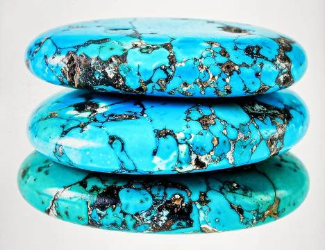A stack of raw turquoise stones with matrix patterns in blue and green, iso.. Stock Photos
