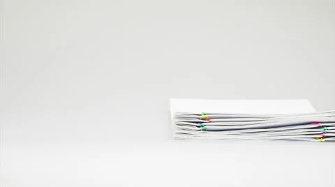 Stack of receipt overload with colorful paper clip time lapse Stock Footage 57967958