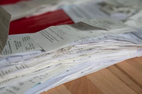 Stack of receipts for tax return purposes laying on wooden table Photos
