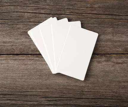 Stack of rectangular white blank business cards on a gray wooden background Stock Photos