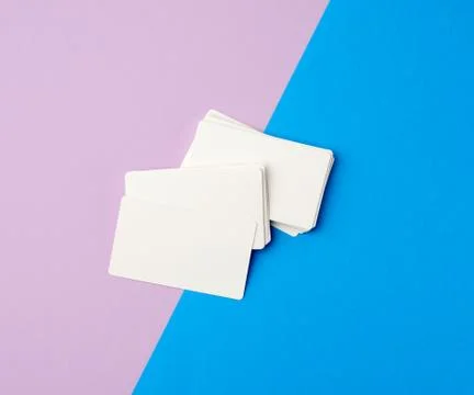 Stack of rectangular white blank business cards on a blue background Stock Photos