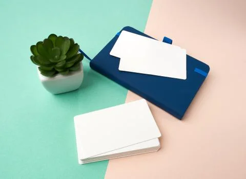 Stack of rectangular white blank business cards on a green beige background Stock Photos