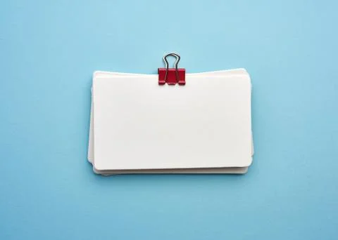 Stack of rectangular white paper blank business cards on blue background Stock Photos