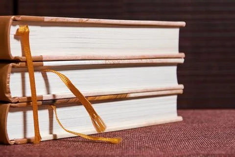 Stack of red ancient books on the brown bookshelf in the library 写真素材