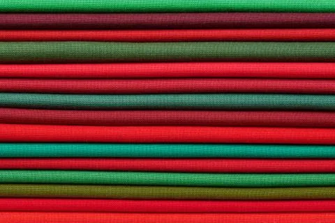 Stack of red and green fabrics as a vibrant background image Fotos de archivo