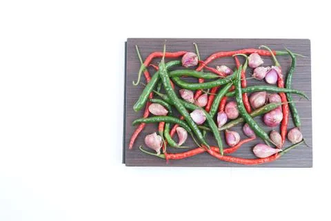 Stack of red and green peppers with red onion Foto stock