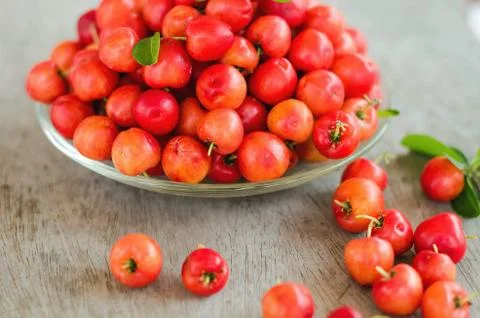 Stack red and sweet cherries on wood background Stock Photos
