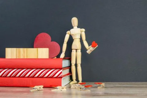 A stack of red books on which there are 4 wooden cubes, and next to there is  스톡 사진