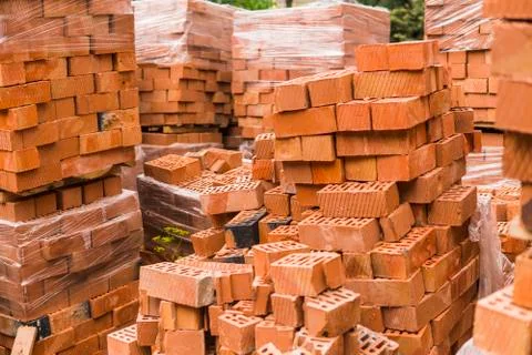 Stack of red brick for construction. Common quality building bricks stacked Stock Photos