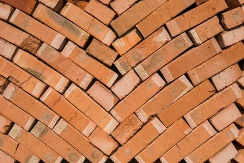 Stack of red bricks as a background or texture. Stockfoto's