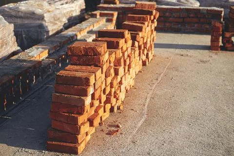 Stack of red bricks on concrete foundation. Building materials at construct.. 写真素材