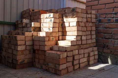 Stack of red bricks on concrete foundation, process of house building. Conc.. 写真素材