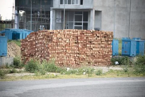 Stack of red bricks on the construction site 库存照片