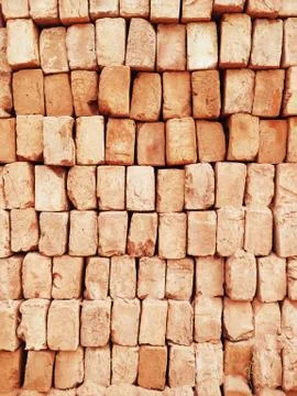 A stack of red bricks fills the frame used to for construction in India 스톡 사진