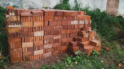 Stack of red bricks at house construction area Stock Photos