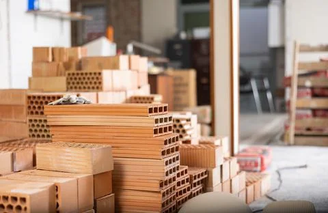 Stack of red bricks inside building under construction Stock Photos