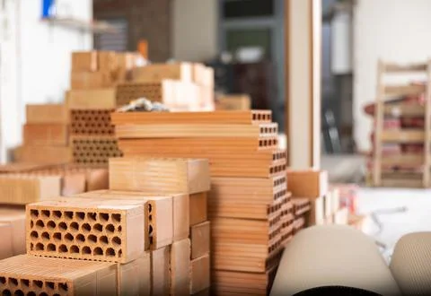 Stack of red bricks inside building under construction Stock Photos