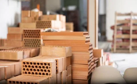 Stack of red bricks inside building under construction Stock Photos