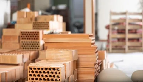 Stack of red bricks inside building under construction Stock Photos