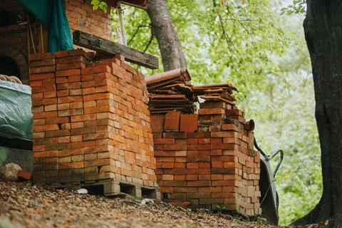 Stack of red bricks on wooden pallets Stock Photos