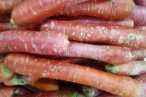 Stack of red carrots on a market stall Stock Photos