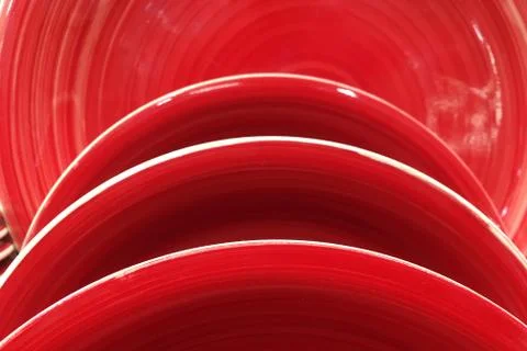 Stack of red ceramic plate dishes Stock Photos