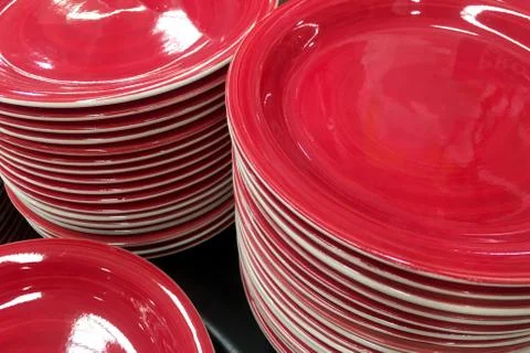 Stack of red ceramic plate dishes Stock Photos