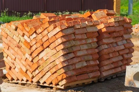 Stack of red clay brick on construction site. Bricks pallet. Red brick Stock Photos