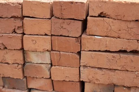 Stack of red clay bricks for construction materials Stock Photos
