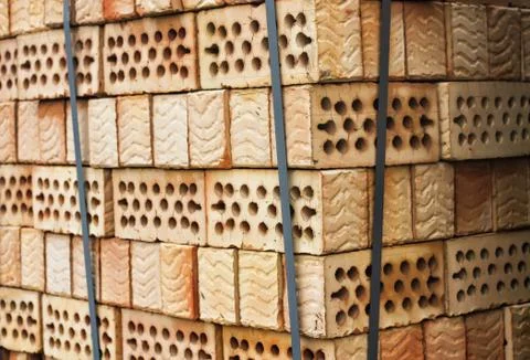 A stack of red clay bricks with holes Stock Photos