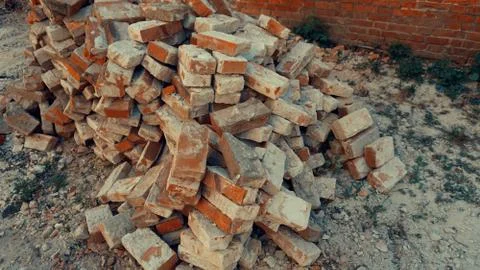 A stack of red clay bricks isolated on the floor 写真素材
