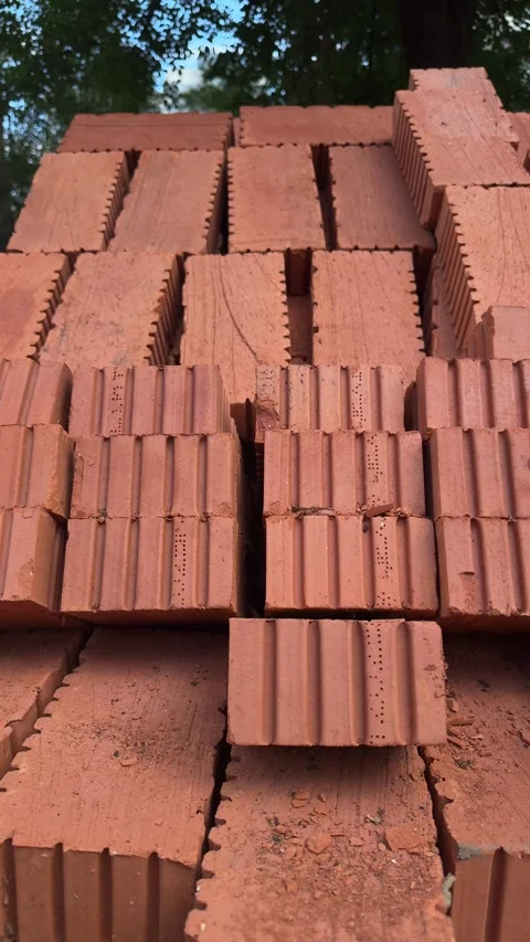 Stack of red clay building bricks outdoors Stock Footage 340997566