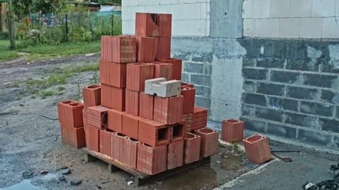 Stack of Red Clay Cinder Block Bricks Prepared for Masonry Wall Laying Construct Stock Footage 279791621