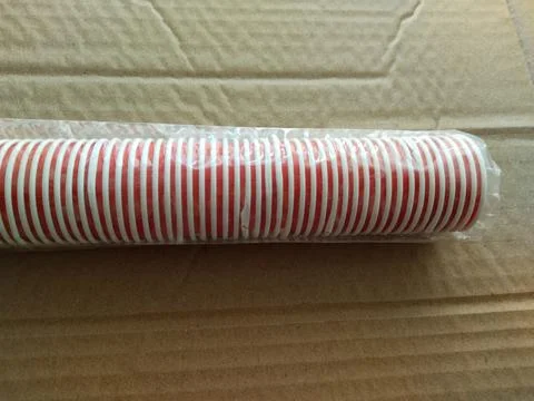 Stack of the red disposable cups isolated on brown background. It's an isol.. Stock Photos