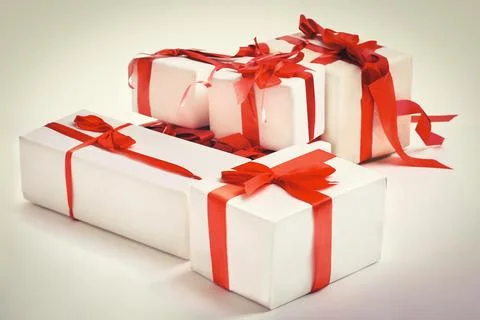 Stack of red gift boxes decorated with bow isolated on white Stock Photos