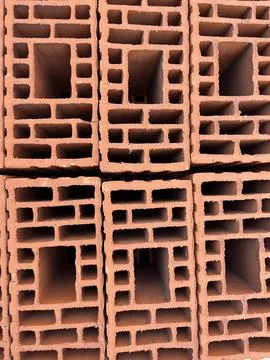 Stack of Red Hollow Clay Bricks Construction Material Stock Photos